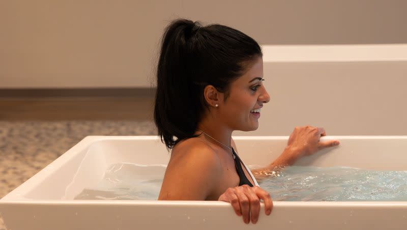 Priscila de Andrade cold-plunges in a tub at Ash and Ice in Pleasant Grove on Friday, Jan. 19, 2024. Cold tub plunge centers are waiting on legislation to be able to open. Andrade is a friend of the owners, and the tub was filled as a demonstration.