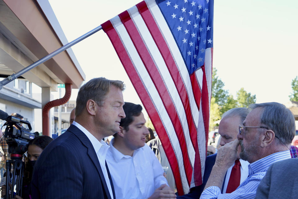 Republican Dean Heller speaks to a supporter outside the Carson City Republican Club on Monday, Sept. 20, 2021 in Carson City, Nev. The former U.S. Senator joins a crowded Republican primary field in what's expected to be among the most competitive gubernatorial races in the United States. (AP Photo/Samuel Metz)