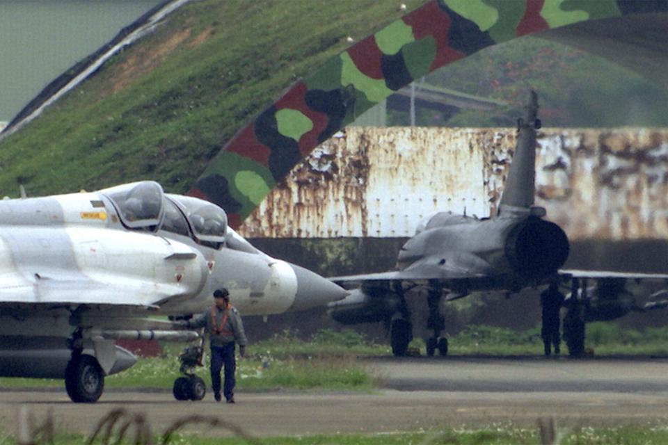In this image made from video, a crew member gives a final check on a mirage fighter jet before taking off at an air base in Hsinchu, Taiwan, Thursday, April 6, 2023. Taiwan's Ministry of National Defense said Wednesday evening it had tracked China's Shandong aircraft carrier passing southeast of Taiwan through the Bashi Strait. On Thursday morning, it tracked three People's Liberation Army navy vessels and one warplane in the area around the island. (AP Photo/Johnson Lai)