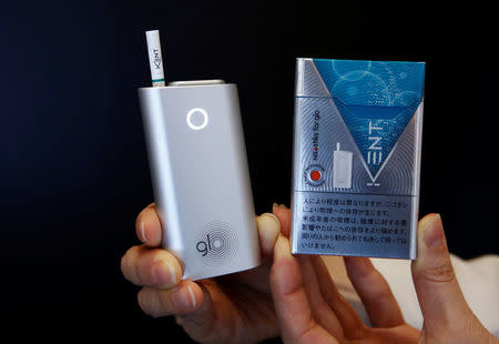 A promoter shows British American Tobacco's new tobacco heating system device 'glo' (L) and Kent tobacco after a news conference in Tokyo, Japan, November 8, 2016. REUTERS/Kim Kyung-Hoon
