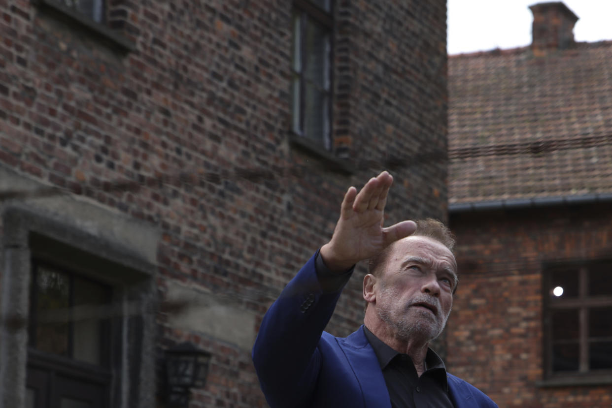 Arnold Schwarzenegger visits Auschwitz - Birkenau Nazi German death camp in Oswiecim, Poland, Wednesday, Sept. 28, 2022. Film icon Schwarzenegger visited the site of the Nazi German death camp Auschwitz on Wednesday to send a message against hatred. The "Terminator" actor was given a tour of the site, viewing the barracks watchtowers and the remains of gas chambers that endure as evidence of the German extermination of Jews, Roma and others during World War II. (AP Photo/Michal Dyjuk)