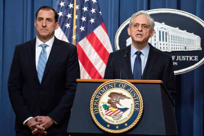 Attorney General Merrick Garland speaks during a news conference at the Department of Justice on Thursday in Washington, as John Lausch, the U.S. Attorney in Chicago, looks on.