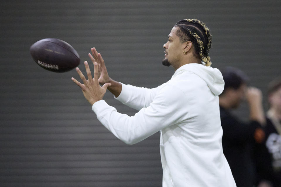 Washington wide reciever Rome Odunze catches the ball during the team's NFL football pro day, Thursday, March 28, 2024, in Seattle. He did not participate in the day. (AP Photo/John Froschauer)
