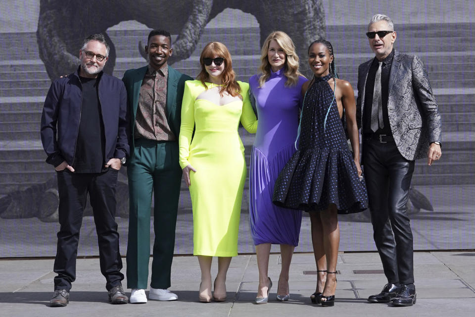 From left, director Colin Trevorrow, actors Mamoudou Athie, Bryce Dallas Howard, Laura Dern, Dewanda Wise and Jeff Goldblum pose for photographers during a photocall for the movie Jurassic World Dominion at Trafalgar Square, London, Friday, May 27, 2022. (Ian West/PA via AP)