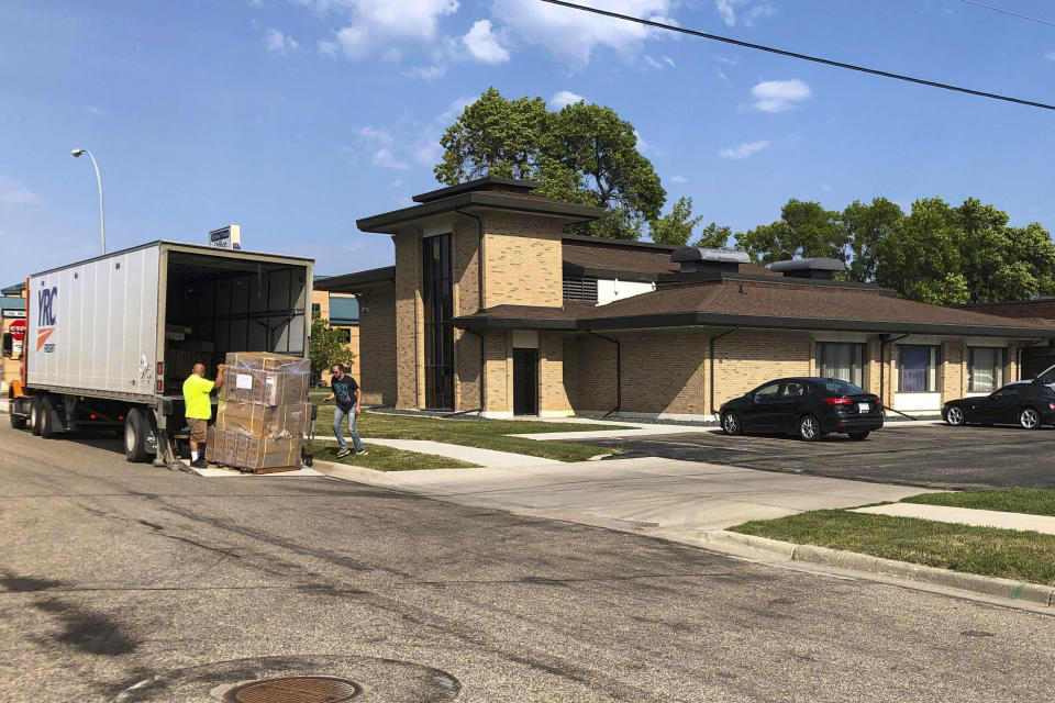 Moving company workers unload boxes for a new abortion clinic that is setting up in a commercial building in Moorhead, Minn., on Friday, Aug. 5, 2022. The Red River Women's Clinic in neighboring Fargo, N.D., is shutting down following the U.S. Supreme Court ruling last month that will in effect ban abortions in North Dakota. Abortion is legal in Minnesota. (AP Photo/Dave Kolpack)