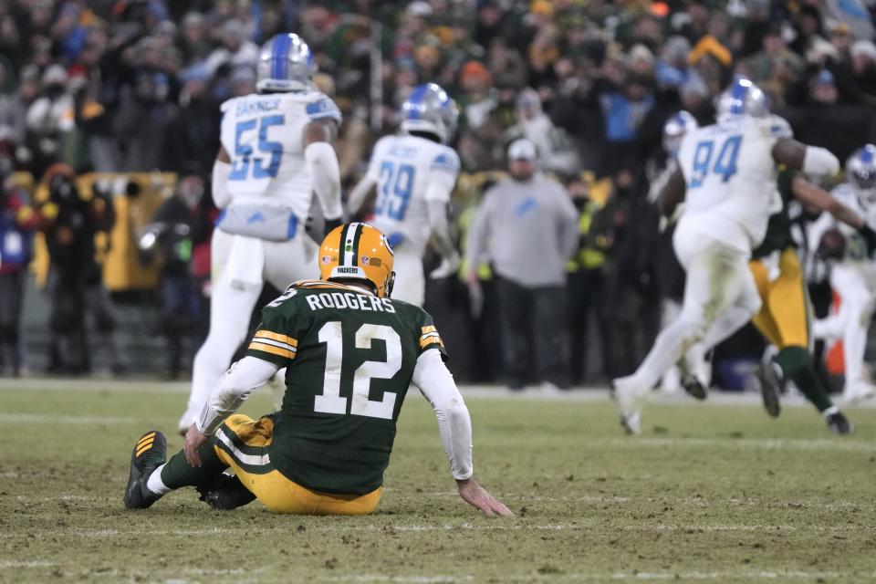 Green Bay Packers quarterback Aaron Rodgers sits on the turf after throwing an interception during the second half at Lambeau Field in Green Bay, Wisconsin, on Sunday, Jan. 8, 2023.