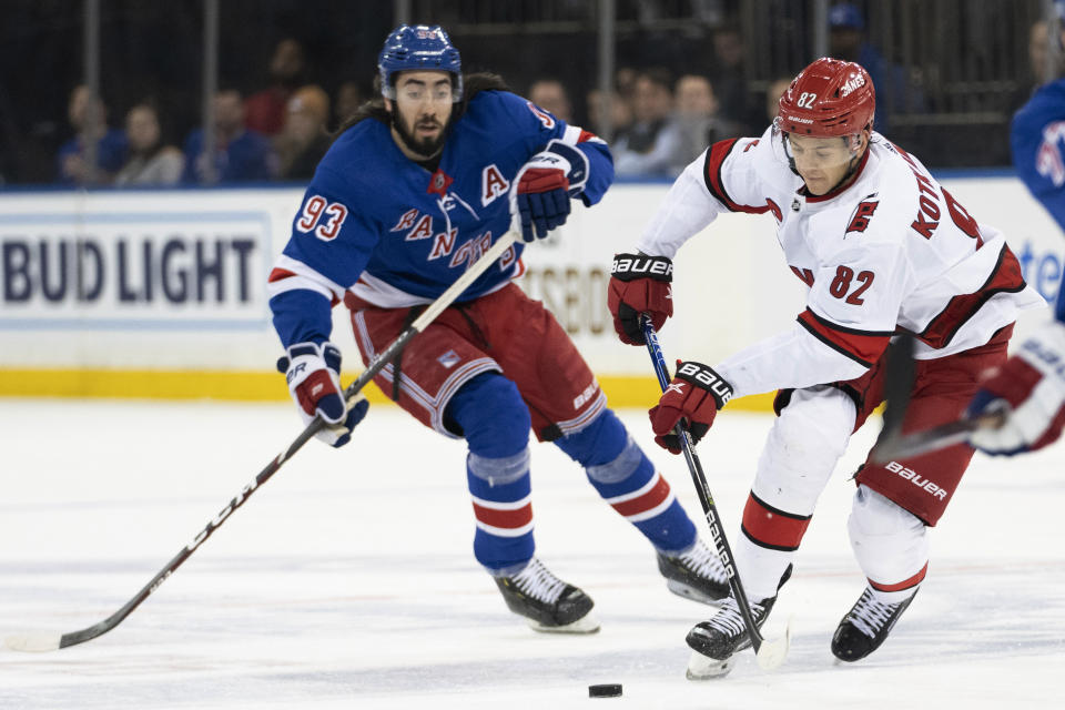 Carolina Hurricanes center Jesperi Kotkaniemi (82) skates against New York Rangers center Mika Zibanejad (93) during the first period of an NHL hockey game Tuesday, March 21, 2023, at Madison Square Garden in New York. (AP Photo/Mary Altaffer)