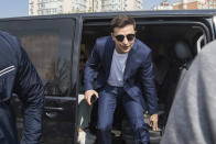 In this photo taken on Sunday, April 21, 2019, Ukrainian comedian and presidential candidate Volodymyr Zelenskiy leaves a minivan as he arrives at a polling station, during the second round of presidential elections in Kiev, Ukraine. For his presidential campaign popular Ukrainian comedian Volodymyr Zelenskiy has literally taken the script from a TV show in which he plays the Ukrainian president. (AP Photo/Zoya Shu)