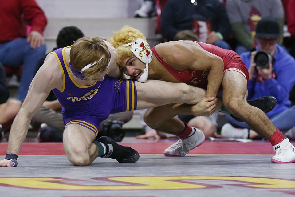 Iowa State wrestler Kysen Terukina, right, goes for a take down against Northern Iowa's Trever Anderson at Hilton Coliseum in Ames on Feb. 11.