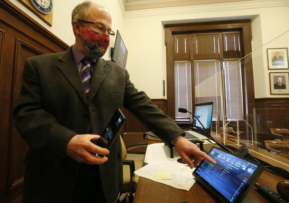 Ken Teleis, who supervises technology in Summit County Common Pleas Court, demonstrates new technology added to Summit County Common Pleas Judge Tammy O'Brien's courtroom in March 2022. The courtroom upgrades were part of the Virtual Court project that improved videoconferencing between the courts and the jail.