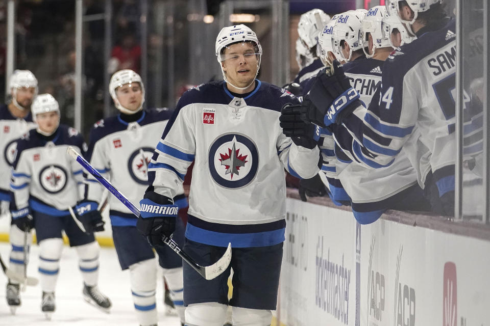 Winnipeg Jets Vladislav Namestnikov (7) gets high-fives from his bench after scoring a goal during the first period of an NHL hockey game against the Arizona Coyotes, Sunday, Jan. 7, 2024, in Tempe, Ariz. (AP Photo/Darryl Webb)