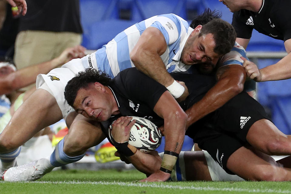CORRECT'S NEW ZEALAND PLAYER'S NAME - New Zealand's David Havili, left, drives through Argentina's Bautista Delguy during their Rugby Championship match on Sunday, Sept. 12, 2021, on the Gold Coast, Australia. (AP Photo/Tertius Pickard)