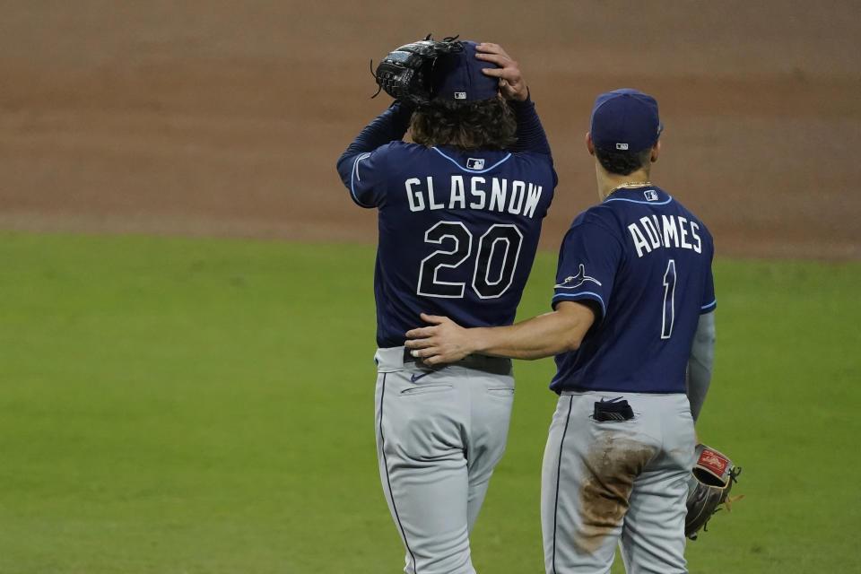 Tampa Bay Rays' Willy Adames talks to starting pitcher Tyler Glasnow during the third inning against the Houston Astros in Game 4 of a baseball American League Championship Series, Wednesday, Oct. 14, 2020, in San Diego. (AP Photo/Ashley Landis)