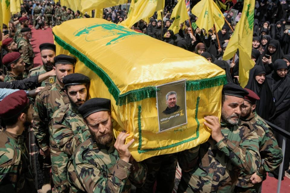 Hezbollah fighters carry the coffin of their comrade, senior commander Taleb Sami Abdullah, 55, known within Hezbollah as Hajj Abu Taleb, who was killed late Tuesday by an Israeli strike in south Lebanon, during his funeral procession in the southern suburbs of Beirut, Lebanon, Wednesday, June 12, 2024 (AP)