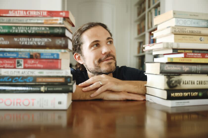 Los Angeles, CA - August 30: Kemper Donovan poses for a portrait with his research materials for Agatha Christie at his home on Tuesday, Aug. 30, 2022 in Los Angeles, CA. He has been recording a podcast called "All About Agatha" that has become beloved among Agatha Christie fans around the world. (Dania Maxwell / Los Angeles Times)