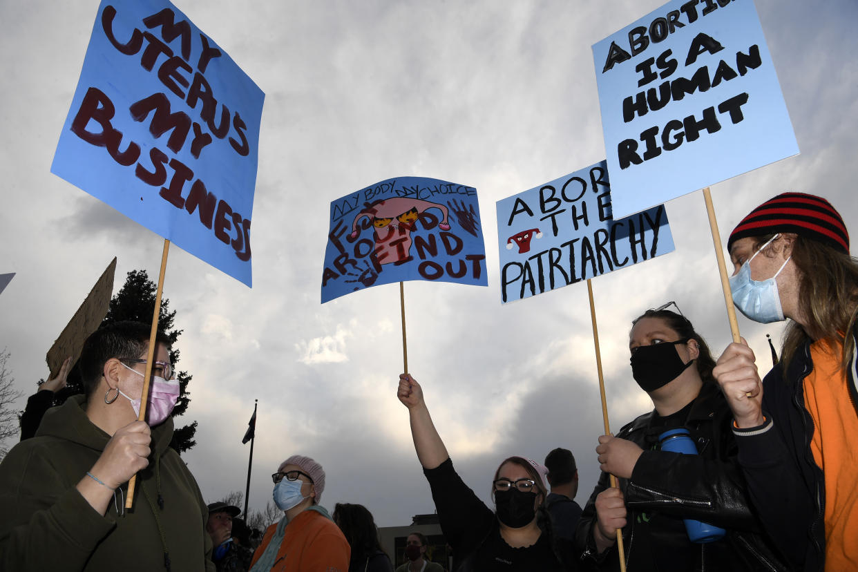 People hold up signs during an abortion rights rally outside of the Colorado State Capitol building in Denver on Tuesday. (Helen H. Richardson/MediaNews Group/The Denver Post via Getty Images)