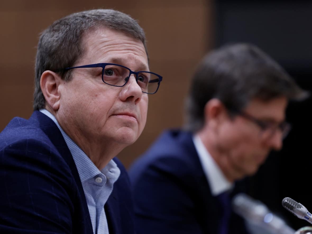 Empire Foods CEO Michael Medline, foreground, and Loblaws chairman and CEO Galen Weston both appeared before a parliamentary committee probing grocery prices on Wednesday. (Blair Gable/Reuters - image credit)