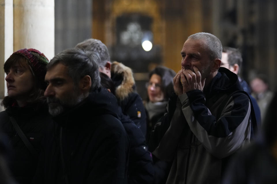 Mourners attend memorial service for the victims of Philosophical Faculty of Charles University shooting in the St. Vitus Cathedral in Prague, Czech Republic, Saturday, Dec. 23, 2023. Czech police are investigating why a student went on a dayslong violent rampage culminating in a shooting at the university he attended in Prague that left 14 dead and dozens wounded. (AP Photo/Petr David Josek)