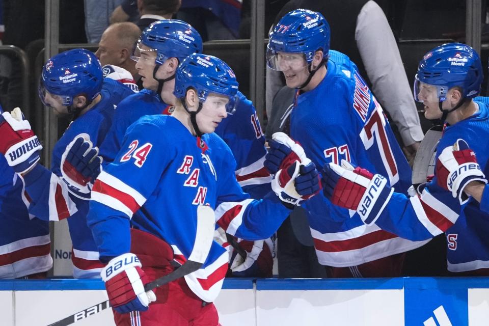 New York Rangers' Kaapo Kakko (24) celebrates with teammates after scoring during the first period of an NHL hockey game against the Seattle Kraken, Friday, Feb. 10, 2023, in New York. (AP Photo/Frank Franklin II)