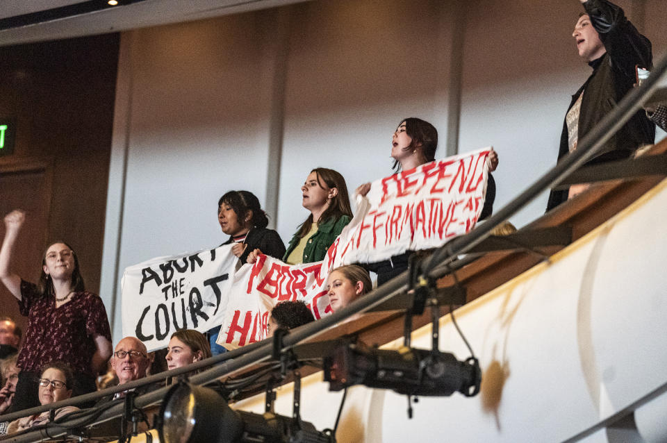 Protesters interrupt the session as U.S. Supreme Court Justice Amy Coney Barrett speaks with Professor Robert A. Stein at Northrop Auditorium as part of the Stein Lecture Series in Minneapolis, Monday, Oct. 16, 2023. (Richard Tsong-Taatarii/Star Tribune via AP)