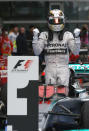 Mercedes driver Lewis Hamilton of Britain celebrates after winning the Chinese Formula One Grand Prix at Shanghai International Circuit in Shanghai, Sunday, April 20, 2014. (AP Photo/Eugene Hoshiko)