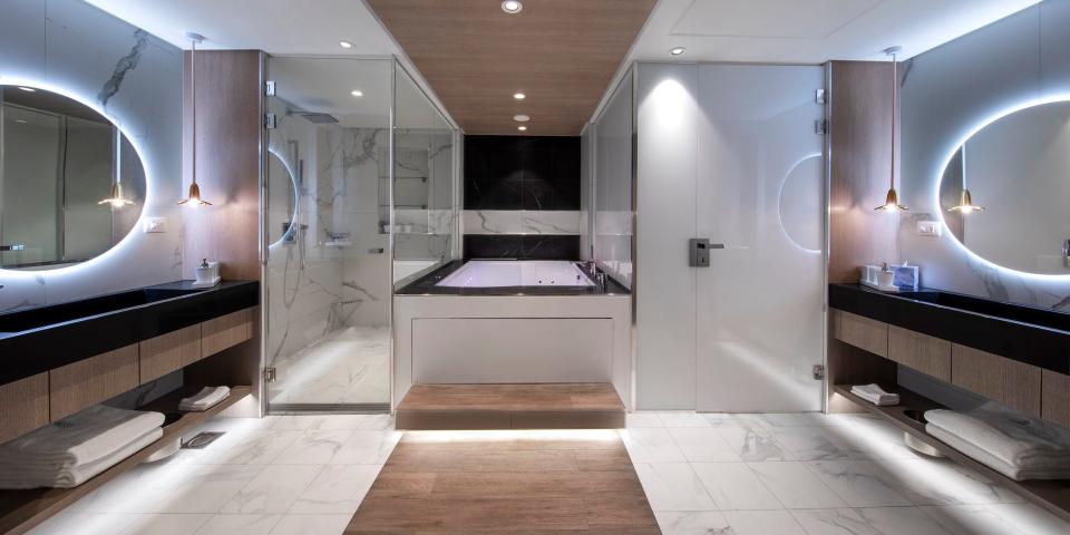 dual vanities, a bathtub, and showers in the Iconic suite aboard the Celebrity Apex cruise ship