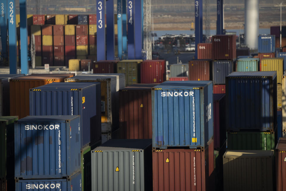 Shipping containers are stacked at a port in Tianjin, China, on Jan. 16, 2023. As technicians in a distant control room watch on display screens, an automated crane at one of China's busiest ports moves cargo containers from a Japanese freighter to self-driving trucks in a scene Chinese tech giant Huawei sees as its future after American sanctions crushed its smartphone brand. (AP Photo/Mark Schiefelbein)