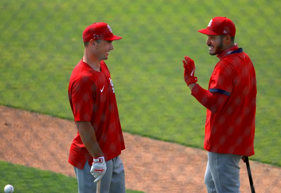 St. Louis Cardinals first baseman Paul Goldschmidt, left, and third baseman Nolan Arenado joke around between batting sessions during a spring training baseball practice in Jupiter, Fla., Monday, Feb. 22, 2021. (Colter Peterson/St. Louis Post-Dispatch via AP)