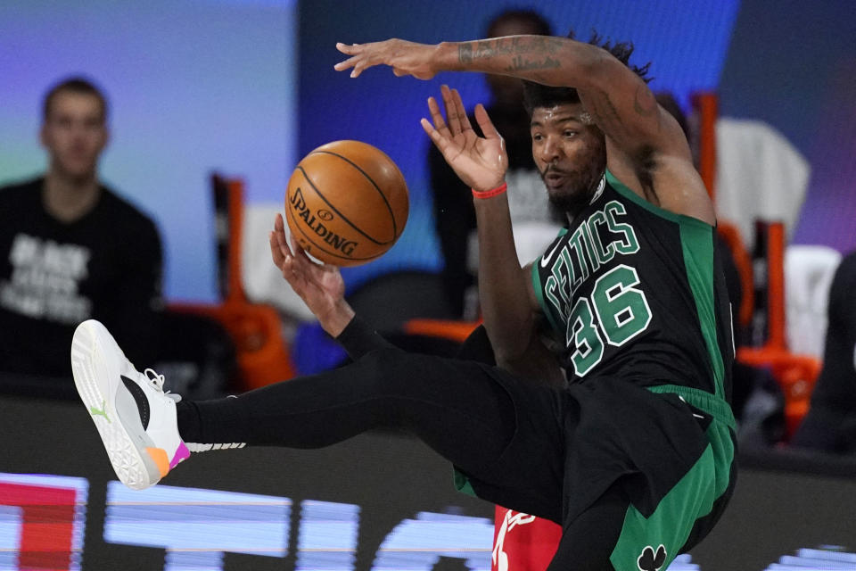 Toronto Raptors' Pascal Siakam, background, is called for a foul as he angles with Boston Celtics' Marcus Smart (36) during the second half of an NBA conference semifinal playoff basketball game Monday, Sept. 7, 2020, in Lake Buena Vista, Fla. (AP Photo/Mark J. Terrill)