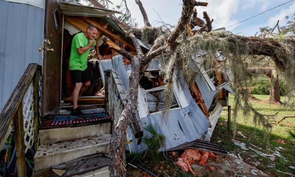 Jeremy Harris, 51, inspects the mobile home he and his mother, Candace Dayton, 66, were sleeping in when a pine tree crashed into their kitchen at 9 AM during Hurricane Idalia at Perry Cove Mobile Home and RV Park in Perry, Florida on Wednesday, August 30, 2023.