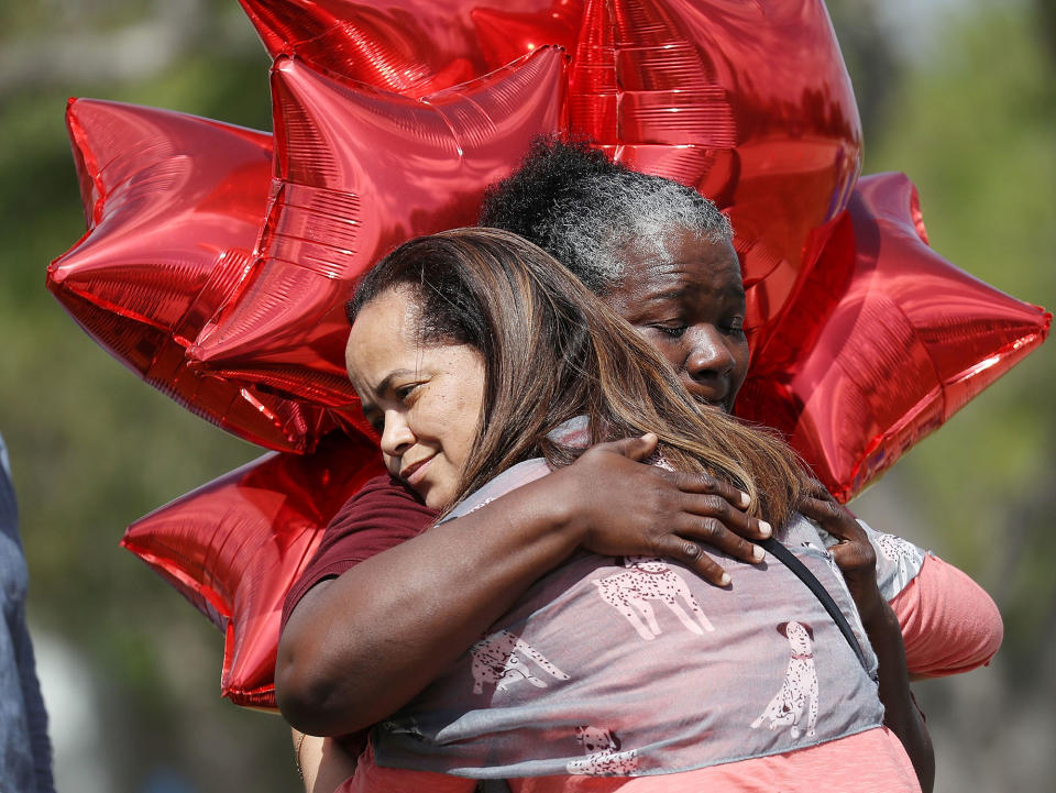 <p>Kay Blake (L) hugs school bus driver Pearlie Corker as they visit in front of Marjory Stoneman Douglas High School as teachers and staff are allowed to return to the school for the first time since the mass shooting on campus on February 23, 2018 in Parkland, Fla. (Photo: Joe Raedle/Getty Images) </p>