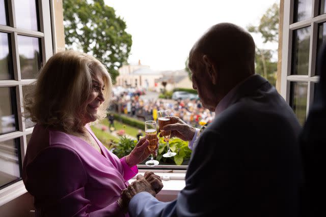 <p>Casey Sykes/Rank Studios</p> Jeanne Swerlin and Harold Terens toast each other at their wedding on June 8, 2024