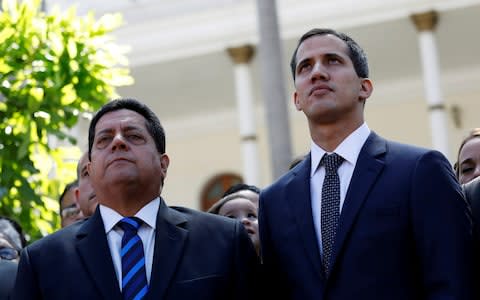 Juan Guaido, right, and Edgar Zambranoleave the congress in Caracas - Credit: Reuters