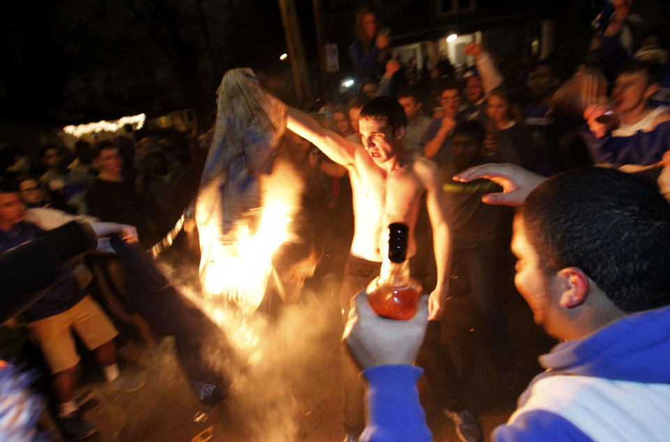 University of Kentucky fans and students take to the streets after the University of Connecticut defeated Kentucky in the NCAA Men's National Basketball Championship near the university campus in Lexington, Kentucky, April 7, 2014. REUTERS/John Sommers II (UNITED STATES - Tags: SPORT BASKETBALL CIVIL UNREST TPX IMAGES OF THE DAY)