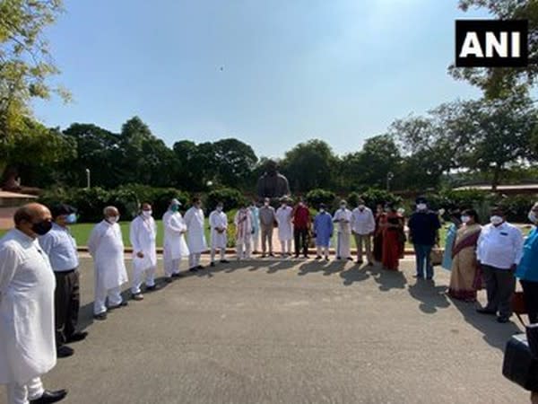Opposition MPs stage protest before Gandhi statue in Parliament premises on Tuesday. Photo/ANI