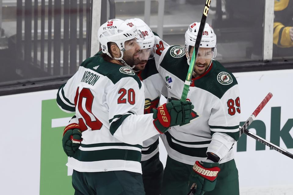 Minnesota Wild's Marcus Johansson (90) celebrates his goal with Pat Maroon (20) and Frederick Gaudreau (89) during the first period of an NHL hockey game against the Boston Bruins, Tuesday, Dec. 19, 2023, in Boston. (AP Photo/Michael Dwyer)