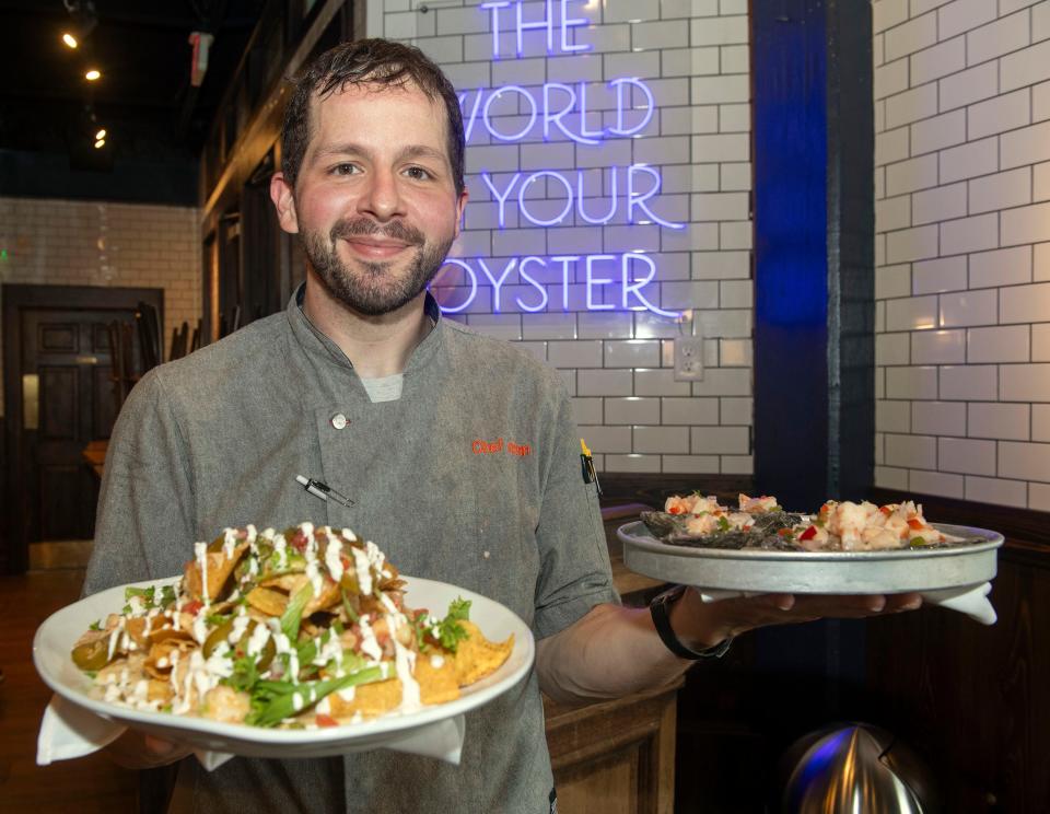 Executive Chef Jason Hughes shows off some of his signature creations on the new Atlas Oyster Bar menu on Monday, July 10, 2023. The Great Southern Restaurant Group is reopening Atlas with a revamped menu and decor later this month. 