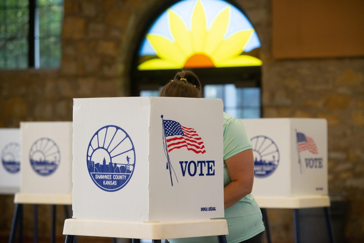 A resident of Shawnee County fills out her ballot for the primary election Tuesday morning at Heritage Hall.