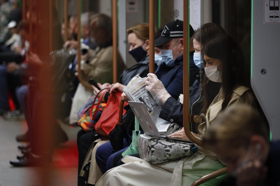 People wearing face mask to help curb the spread of the coronavirus ride a subway car in Moscow, Russia, Thursday, June 10, 2021. The Russian authorities reported a spike in coronavirus infections on Thursday, with new confirmed cases exceeding 11,000 for the first time since March. (AP Photo/Alexander Zemlianichenko)