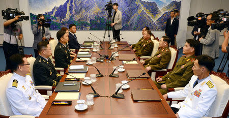 North Korean Lieutenant General An Ik San talks with South Korean Major General Kim Do-gyun during a meeting at the Peace House of the border village of Panmunjom, South Korea, July 31, 2018. Yonhap via REUTERS