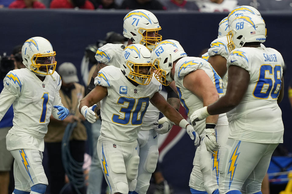 Los Angeles Chargers running back Austin Ekeler (30) celebrates with teammates after scoring a touchdown against the Houston Texans during the second half of an NFL football game Sunday, Oct. 2, 2022, in Houston. (AP Photo/David J. Phillip)