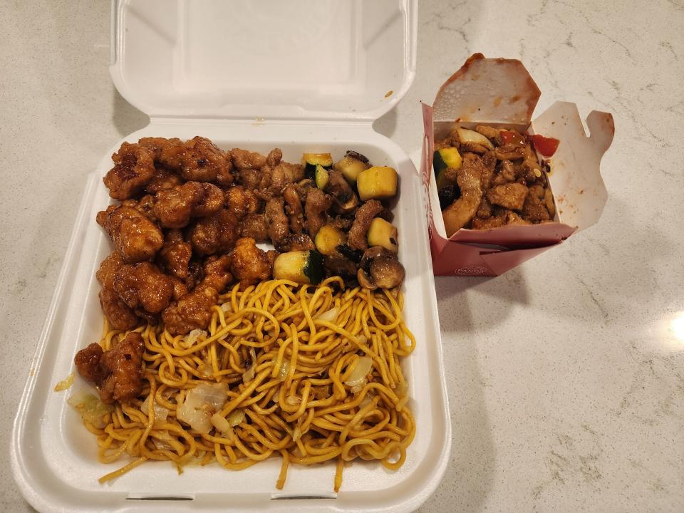 A bigger plate from Panda Express with chow mein, orange chicken, kung pao chicken, and mushroom chicken