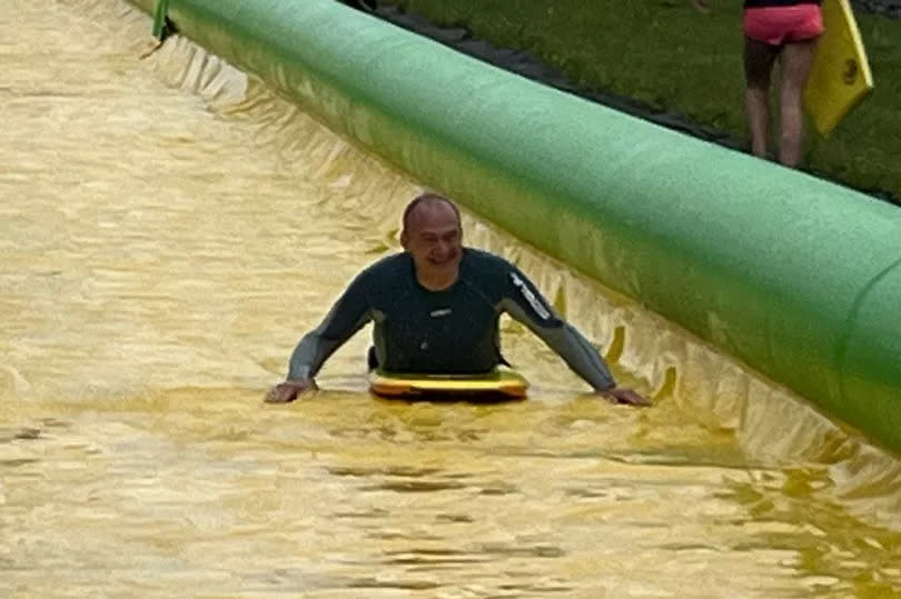 Leader of Liberal Democrats Sir Ed Davey after he rode down the Ultimate Slip n Slide attraction near Frome, Somerset, while on the General Election campaign trail.