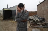 Circus clown Julio Cesar Chiroque, 38, whose clown name is "Galleta," or Cookie, tears up as he explains his family's dire economic situation brought by the economic shutdown to curb the spread of COVID-19 outside his home in a poor neighborhood on the outskirts of Lima, Peru, Monday, Aug. 10, 2020. Chiroque's family used to run their own small circus, but since March when the lockdown to curb COVID-19 closed their business, and the requirement for seniors over 60 to self-quarantine kept his father home-bound, they started selling circus food like caramelized apples to survive. (AP Photo/Martin Mejia)