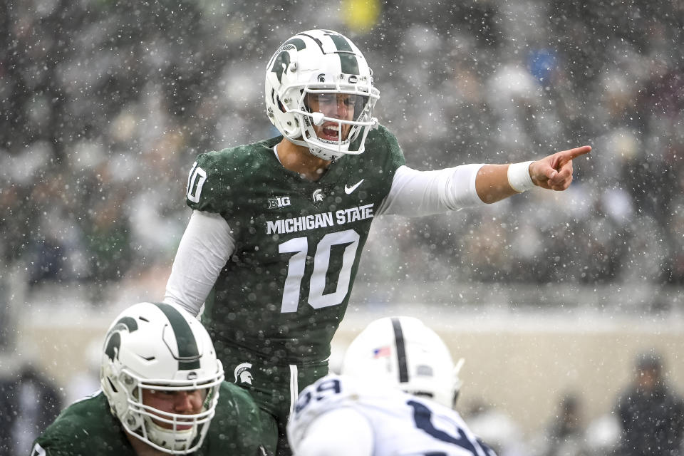 EAST LANSING, MICHIGAN - NOVEMBER 27: Payton Thorne #10 of the Michigan State Spartans talks with his team at the line of scrimmage against the Penn State Nittany Lions at Spartan Stadium on November 27, 2021 in East Lansing, Michigan. (Photo by Nic Antaya/Getty Images)