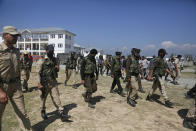 Indian police officers arrive to pay respects to slain colleagues, during a wreath laying ceremony at a base camp at shopian, about 63 kilometers south of Srinagar, Indian controlled Kashmir, Friday, Sept. 21, 2018. Anti-India rebels in disputed Kashmir raided over a dozen homes of police officers and abducted three whose bullet-riddled were recovered Friday, officials said. The killings came days after the region's largest rebel group asked officers to quit the Kashmiri police force and stay away from counterinsurgency operations. (AP Photo/Mukhtar Khan)