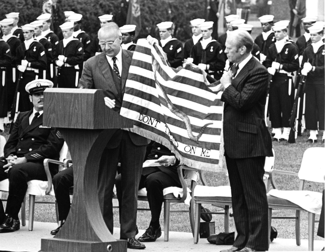 President Gerald R. Ford, right, receives the prototype of the ceremonial Continental Navy Jack from Navy Secretary J. William Middendorf during an October 1975 ceremony in Washington. A smaller version of the flag was flown from the jack staff of every U.S. Navy ship in December 1976 as part of the Navy's bicentennial celebration.