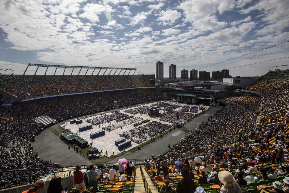 The crowd watches as Pope Francis celebrates mass at Commonwealth Stadium in Edmonton, during his papal visit across Canada on Tuesday, July 26, 2022. (Jason Franson /The Canadian Press via AP)