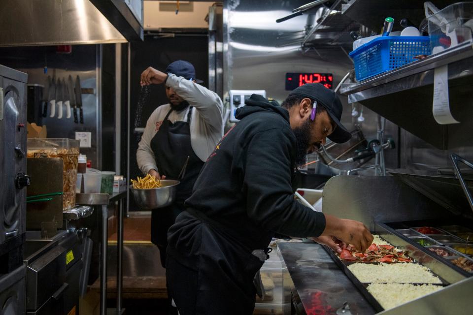 Executive chef Michael Carter, right, and Myles Jackson work in the kitchen at Down North in Philadelphia.