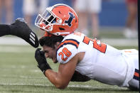 Illinois linebacker Dylan Rosiek loses his helmet while trying to tackle Kansas running back Devin Neal during the first half of an NCAA college football game Friday, Sept. 8, 2023, in Lawrence, Kan. (AP Photo/Charlie Riedel)
